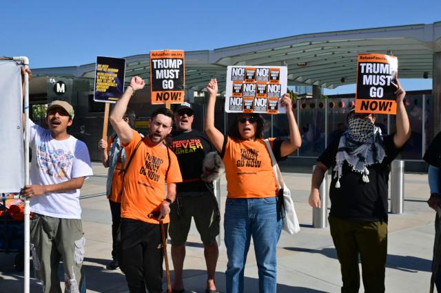 Protestors hold signs during a rally against US military action in Iran during a demonstration in Los Angeles on April 7, 2026. On April 7, US President Donald Trump warned that "a whole civilization will die" in Iran if the country does not heed his midnight cutoff to open the Strait of Hormuz, as Tehran reported US-Israeli attacks on its infrastructure were already underway. (Photo by Frederic J. Brown / AFP)