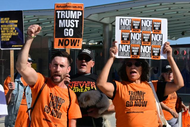 Protestors hold signs during a rally against US military action in Iran during a demonstration in Los Angeles on April 7, 2026. On April 7, US President Donald Trump warned that "a whole civilization will die" in Iran if the country does not heed his midnight cutoff to open the Strait of Hormuz, as Tehran reported US-Israeli attacks on its infrastructure were already underway. (Photo by Frederic J. Brown / AFP)