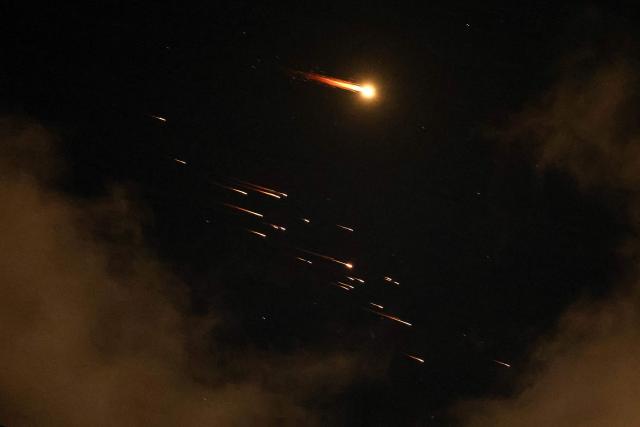 Rocket trails are seen in the sky above the Netanya, Israel, on April 8, 2026. Israel's military issued two warnings in quick succession early Wednesday that Iran had fired missiles toward it, moments after US President Donald Trump said he had agreed to postpone striking Iranian infrastructure. (Photo by JACK GUEZ / AFP) / 