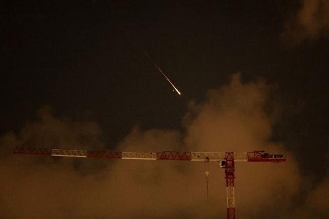 Rocket trails are seen in the sky above the Netanya, Israel, on April 8, 2026. Israel's military issued two warnings in quick succession early Wednesday that Iran had fired missiles toward it, moments after US President Donald Trump said he had agreed to postpone striking Iranian infrastructure. (Photo by JACK GUEZ / AFP) / 