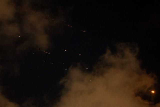 Rocket trails are seen in the sky above the Netanya, Israel, on April 8, 2026. Israel's military issued two warnings in quick succession early Wednesday that Iran had fired missiles toward it, moments after US President Donald Trump said he had agreed to postpone striking Iranian infrastructure. (Photo by JACK GUEZ / AFP) / 
