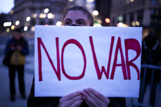 A demonstrator holds a sign during a protest against US military action in Iran in the Manhattan borough of New York City on April 7, 2026. US President Donald Trump said on April 7 he agreed to suspend bombing of Iran for two weeks as part of a ceasefire deal if Tehran completely reopens the vital Strait of Hormuz. The announcement came after Pakistan made a last-minute proposal to avert massive US attacks on Iran, with Trump warning a "whole civilization will die tonight" unless a deal was agreed. (Photo by CHARLY TRIBALLEAU / AFP)