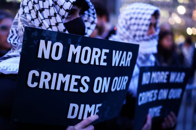 Demonstrators hold signs during a protest against US military action in Iran in the Manhattan borough of New York City on April 7, 2026. US President Donald Trump said on April 7 he agreed to suspend bombing of Iran for two weeks as part of a ceasefire deal if Tehran completely reopens the vital Strait of Hormuz. The announcement came after Pakistan made a last-minute proposal to avert massive US attacks on Iran, with Trump warning a "whole civilization will die tonight" unless a deal was agreed. (Photo by CHARLY TRIBALLEAU / AFP)