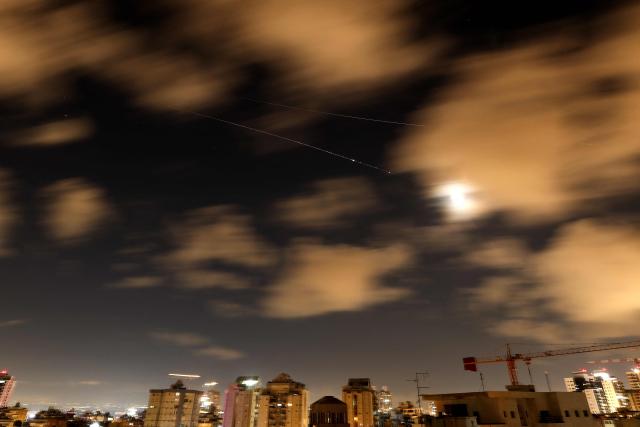 Rocket trails are seen in the sky above the Netanya, Israel, on April 8, 2026. Israel's military issued two warnings in quick succession early Wednesday that Iran had fired missiles toward it, moments after US President Donald Trump said he had agreed to postpone striking Iranian infrastructure. (Photo by JACK GUEZ / AFP) / 
