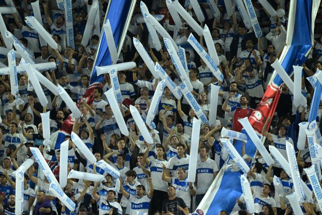 Fans of Universidad Catolica cheer for their team during the Copa Libertadores group stage football match between Chile's Universidad Catolica and Argentina's Boca Juniors at the Claro Arena stadium in Santiago on April 7, 2026. (Photo by Rodrigo ARANGUA / AFP)