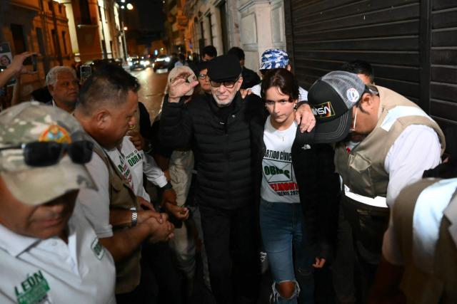 Peru's presidential candidate Ricardo Belmont (C), for the Civico Obras party, greets supporters accompanied by his daughter Kristen Belmont upon arrival at his closing campaign rally at San Martin Square in Lima on April 7, 2026. Peru will hold presidential elections on April 12. (Photo by Luis ROBAYO / AFP)