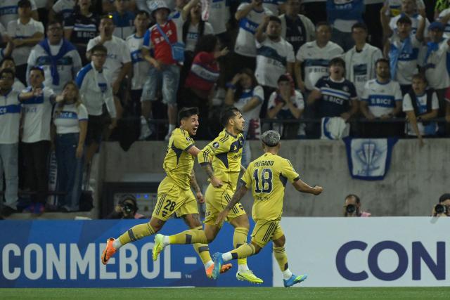 Boca Juniors' midfielder #05 Leandro Paredes (C) celebrates with teammates Paraguayan forward #28 Adam Bareiro and midfielder #18 Milton Delgado scoring the opening goal during the Copa Libertadores group stage football match between Chile's Universidad Catolica and Argentina's Boca Juniors at the Claro Arena stadium in Santiago on April 7, 2026. (Photo by Rodrigo ARANGUA / AFP)