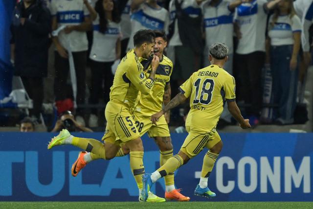 Boca Juniors' midfielder #05 Leandro Paredes (R) celebrates with teammates Paraguayan forward #28 Adam Bareiro and midfielder #18 Milton Delgado scoring the opening goal during the Copa Libertadores group stage football match between Chile's Universidad Catolica and Argentina's Boca Juniors at the Claro Arena stadium in Santiago on April 7, 2026. (Photo by Rodrigo ARANGUA / AFP)