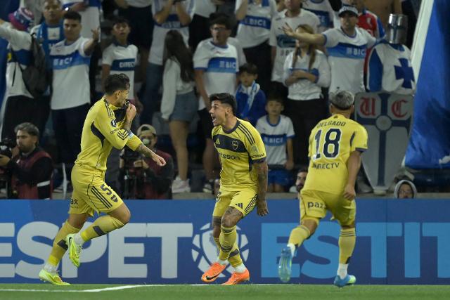 Boca Juniors' midfielder #05 Leandro Paredes (L) celebrates with teammates Paraguayan forward #28 Adam Bareiro and midfielder #18 Milton Delgado scoring the opening goal during the Copa Libertadores group stage football match between Chile's Universidad Catolica and Argentina's Boca Juniors at the Claro Arena stadium in Santiago on April 7, 2026. (Photo by Rodrigo ARANGUA / AFP)
