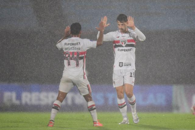 Sao Paulo's midfielder #16 Damián Bobadilla (R) celebrates with teammate midfielder #94 Danielzinho scoring the opening goal during the Copa Sudamericana group stage football match between Uruguay's Boston River and Brazil's Sao Paulo at the Centenario stadium in Montevideo on April 7, 2026. (Photo by Dante FERNANDEZ / AFP)