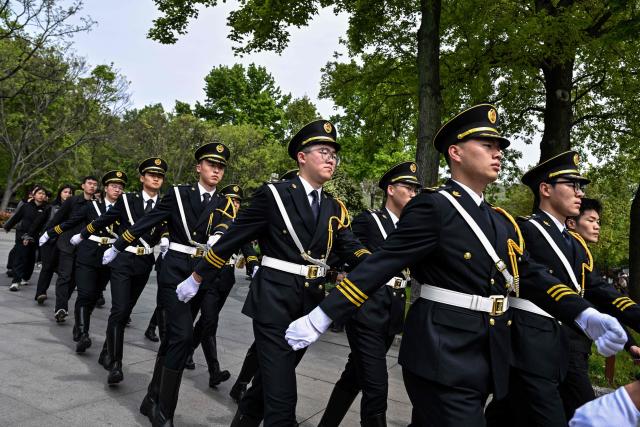 Honour guards walk through Zhongshan Mountain National Park after Kuomintang Chairperson Cheng Li-wen visited the Sun Yat-Sen Mausoleum in Nanjing on April 8, 2026. Taiwan's main opposition leader landed in China on April 7 for a rare visit aimed at building cross-strait "peace", as the Taipei government warned Beijing would seek to stop US arms sales to the democratic island. (Photo by HECTOR RETAMAL / AFP)