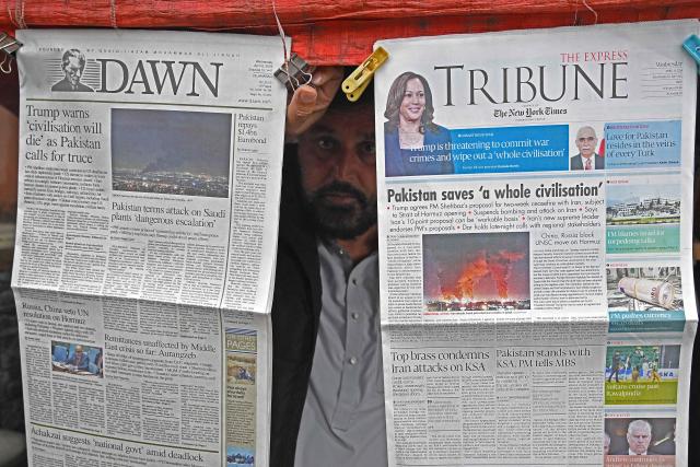 A vendor displays morning newspapers at his roadside stall in Islamabad on April 8, 2026. Pakistan's Prime Minister Shehbaz Sharif said on April 8 that the United States, Iran and their allies had agreed to a ceasefire "everywhere", including Lebanon, following mediation by his government to stop weeks of fighting. (Photo by Aamir QURESHI / AFP)