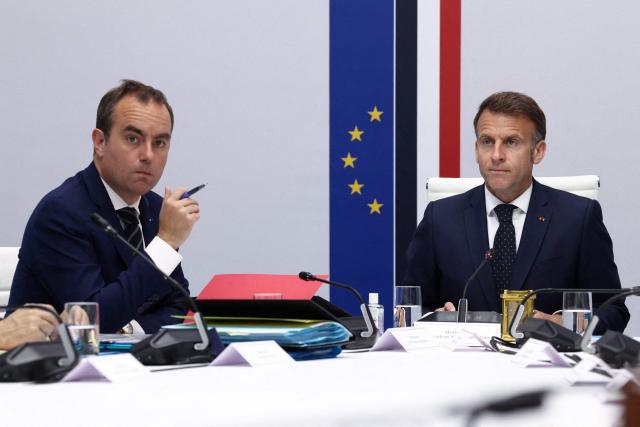 French President Emmanuel Macron (R) and Prime Minister Sebastien Lecornu attend a national defence council meeting on Middle East war at The Elysee Presidential Palace in Paris on April 8, 2026. French nationals, who spent more than three years in an Iranian prison on espionage charges, headed home from the war-stricken country on April, 7, 2026 Macron said. (Photo by Tom Nicholson / POOL / AFP)