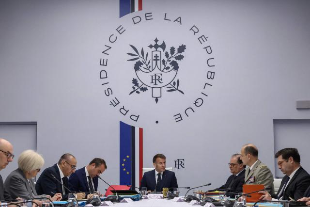 France's President Emmanuel Macron (C), with France's Prime Minister Sebastien Lecornu (L), France's Interior Minister Laurent Nunez (2ndL), France's Defence Minister Catherine Vautrin (3rdL) and Chief of the Military Staff of the President of the Republic Vincent Giraud (2ndR), addresses a national defence council meeting on Middle East war at The Elysee Presidential Palace in Paris on April 8, 2026. French nationals, who spent more than three years in an Iranian prison on espionage charges, headed home from the war-stricken country on April, 7, 2026 Macron said. (Photo by Tom Nicholson / POOL / AFP)