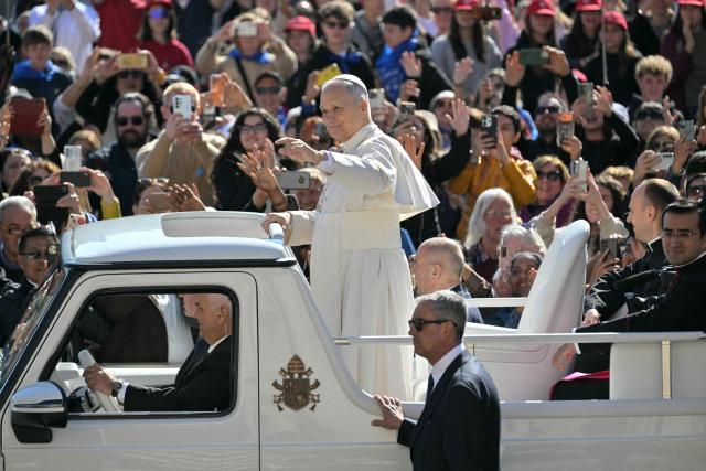 Pope Leo XIV waves to the crowd during the weekly general audience at St Peter's Square in The Vatican on April 8, 2026. (Photo by Tiziana FABI / AFP)