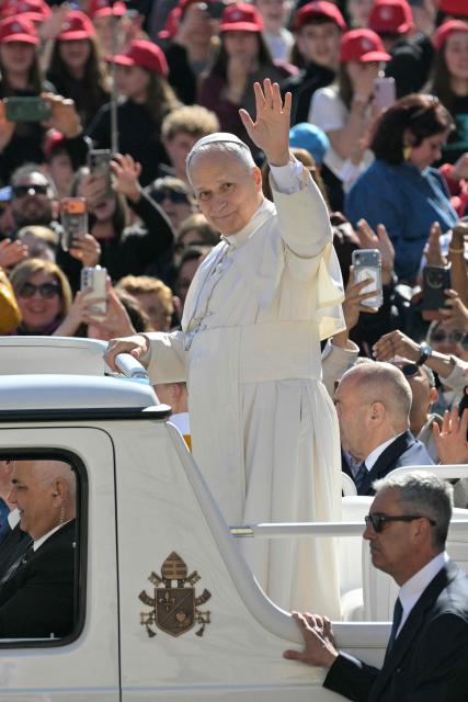 Pope Leo XIV waves to the crowd during the weekly general audience at St Peter's Square in The Vatican on April 8, 2026. (Photo by Tiziana FABI / AFP)