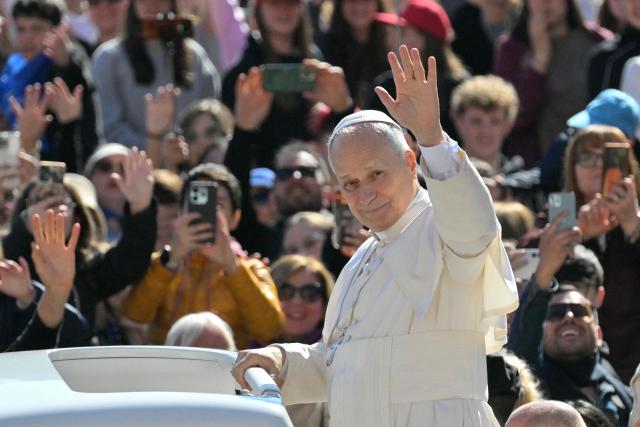 Pope Leo XIV waves to the crowd during the weekly general audience at St Peter's Square in The Vatican on April 8, 2026. (Photo by Tiziana FABI / AFP)