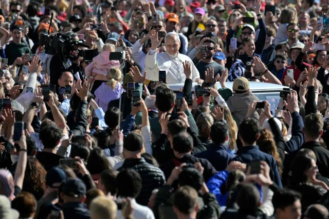 Pope Leo XIV waves to the crowd during the weekly general audience at St Peter's Square in The Vatican on April 8, 2026. (Photo by Tiziana FABI / AFP)