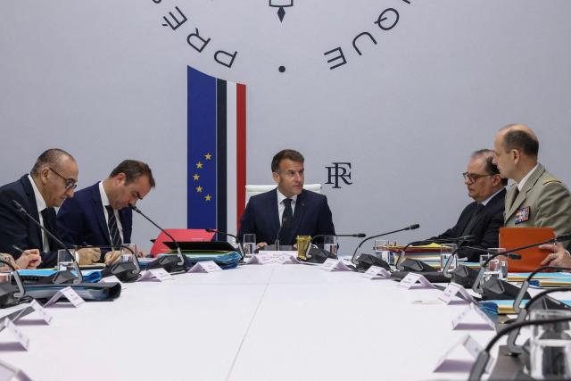 France's President Emmanuel Macron, with France's Prime Minister Sebastien Lecornu (L), France's Interior Minister Laurent Nunez (2ndL) and Chief of the Military Staff of the President of the Republic Vincent Giraud (R) addresses a national defence council meeting on Middle East war at The Elysee Presidential Palace in Paris on April 8, 2026. French nationals, who spent more than three years in an Iranian prison on espionage charges, headed home from the war-stricken country on April, 7, 2026 Macron said. (Photo by Tom Nicholson / POOL / AFP)