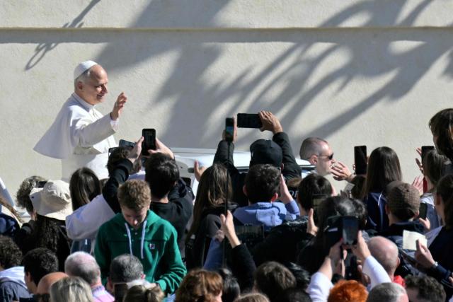 Pope Leo XIV waves to the crowd during the weekly general audience at St Peter's Square in The Vatican on April 8, 2026. (Photo by Tiziana FABI / AFP)