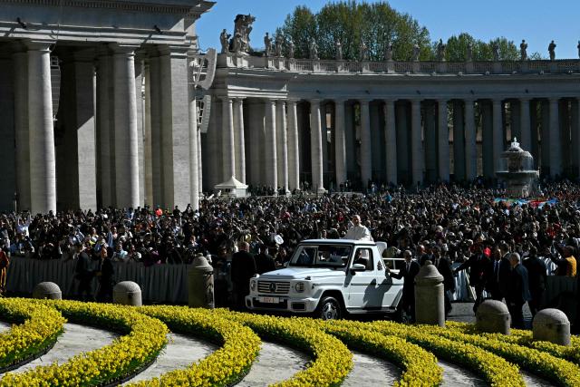 Pope Leo XIV waves to the crowd during the weekly general audience at St Peter's Square in The Vatican on April 8, 2026. (Photo by Tiziana FABI / AFP)