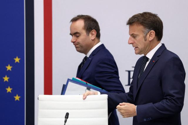 France's President Emmanuel Macron (R) and France's Prime Minister Sebastien Lecornu arrive at the national defence council meeting on Middle East war at The Elysee Presidential Palace in Paris on April 8, 2026. French nationals, who spent more than three years in an Iranian prison on espionage charges, headed home from the war-stricken country on April, 7, 2026 Macron said. (Photo by Tom Nicholson / POOL / AFP)