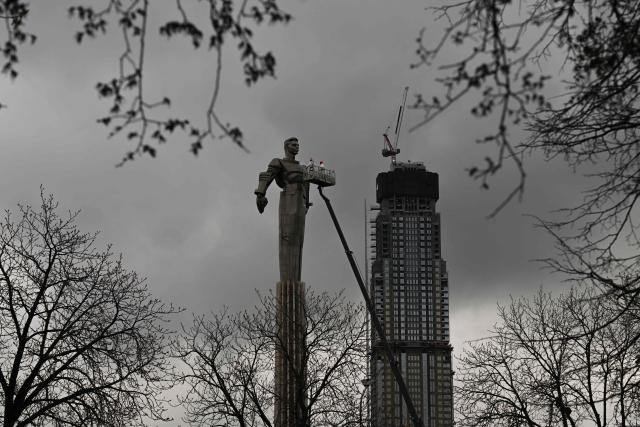 Maintenance workers clean the monument of Soviet cosmonaut Yuri Gagarin in Moscow on April 8, 2026. Sixty five years ago Soviet cosmonaut Yuri Gagarin became the first person in space, marking it a new chapter in the history of space exploration. (Photo by Igor IVANKO / AFP)