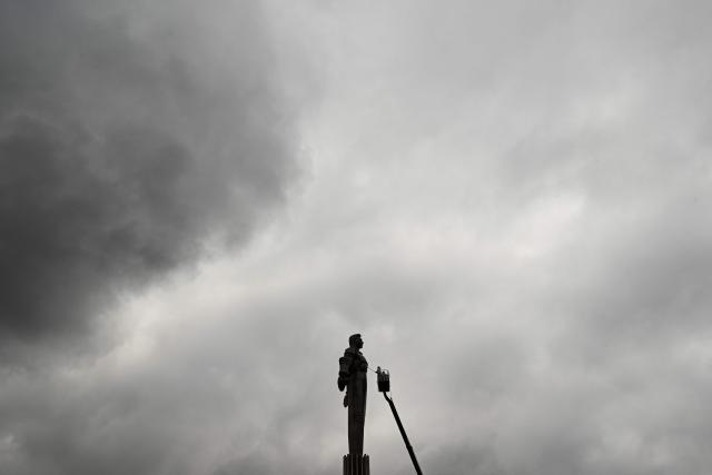Maintenance workers clean the monument of Soviet cosmonaut Yuri Gagarin in Moscow on April 8, 2026. Sixty five years ago Soviet cosmonaut Yuri Gagarin became the first person in space, marking it a new chapter in the history of space exploration. (Photo by Igor IVANKO / AFP)