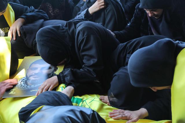 Mourners attend the funeral of a Hezbollah fighter at a temporary graveyard in Choueifat, south of Beirut, on April 8, 2026. Israel's military said on April 8, its forces would continue their campaign against Hezbollah fighters, claiming the ceasefire with Iran does not apply to Lebanon. (Photo by ibrahim AMRO / AFP)