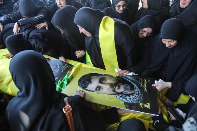Mourners attend the funeral of a Hezbollah fighter at a temporary graveyard in Choueifat, south of Beirut, on April 8, 2026. Israel's military said on April 8, its forces would continue their campaign against Hezbollah fighters, claiming the ceasefire with Iran does not apply to Lebanon. (Photo by ibrahim AMRO / AFP)
