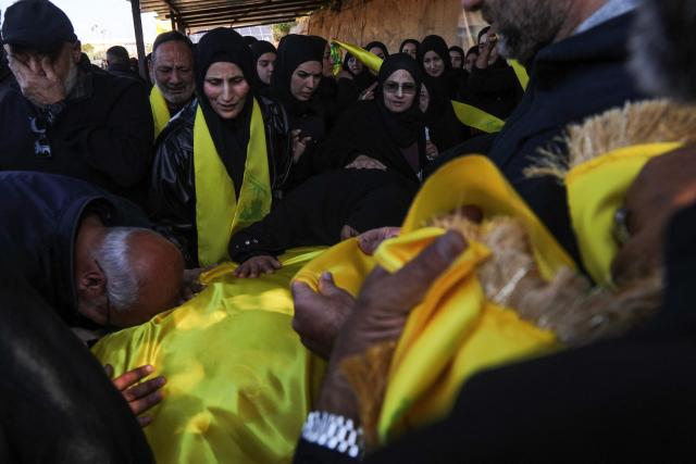 Mourners react during the funeral of a Hezbollah fighter at a temporary graveyard in Choueifat, south of Beirut, on April 8, 2026. Israel's military said on April 8, its forces would continue their campaign against Hezbollah fighters, claiming the ceasefire with Iran does not apply to Lebanon. (Photo by ibrahim AMRO / AFP)
