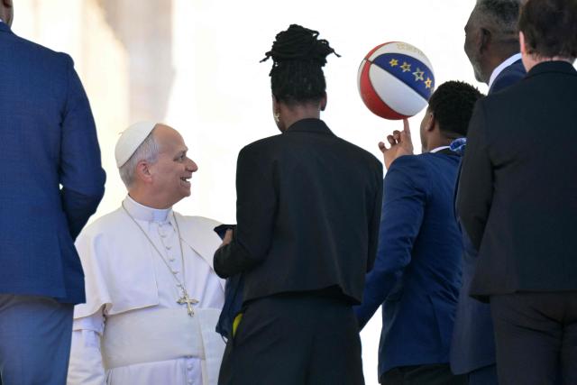 Members of the Harlem Globetrotters meet with Pope Leo XIV at the end of the weekly general audience at St Peter's Square in The Vatican on April 8, 2026. (Photo by Tiziana FABI / AFP)