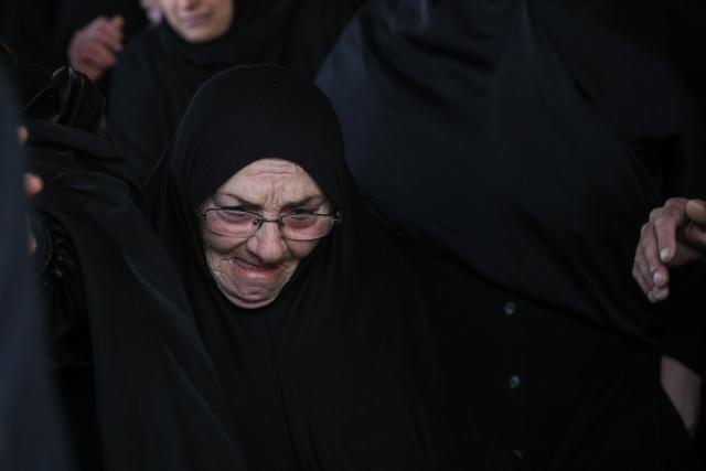 A woman mourns during the funeral of a Hezbollah fighter at a temporary graveyard in Choueifat, south of Beirut, on April 8, 2026. Israel's military said on April 8, its forces would continue their campaign against Hezbollah fighters, claiming the ceasefire with Iran does not apply to Lebanon. (Photo by ibrahim AMRO / AFP)