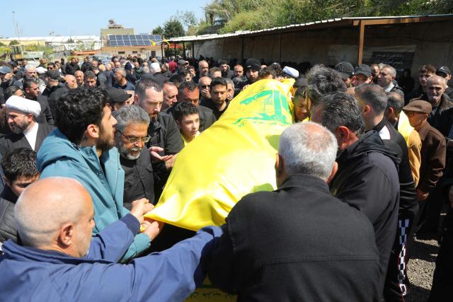 Mourners attend the funeral of a Hezbollah fighter at a temporary graveyard in Choueifat, south of Beirut, on April 8, 2026. Israel's military said on April 8, its forces would continue their campaign against Hezbollah fighters, claiming the ceasefire with Iran does not apply to Lebanon. (Photo by ibrahim AMRO / AFP)