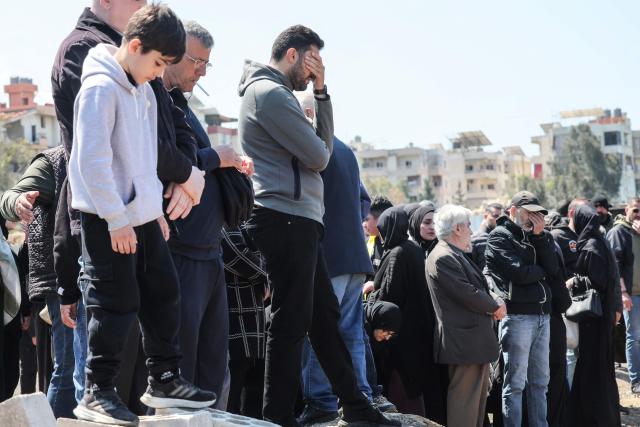 Mourners attend the funeral of a Hezbollah fighter at a temporary graveyard in Choueifat, south of Beirut, on April 8, 2026. Israel's military said on April 8, its forces would continue their campaign against Hezbollah fighters, claiming the ceasefire with Iran does not apply to Lebanon. (Photo by ibrahim AMRO / AFP)