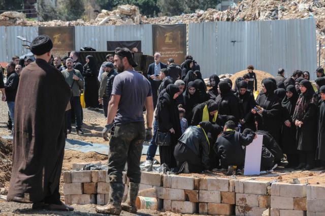 Mourners attend the funeral of a Hezbollah fighter at a temporary graveyard in Choueifat, south of Beirut, on April 8, 2026. Israel's military said on April 8, its forces would continue their campaign against Hezbollah fighters, claiming the ceasefire with Iran does not apply to Lebanon. (Photo by ibrahim AMRO / AFP)