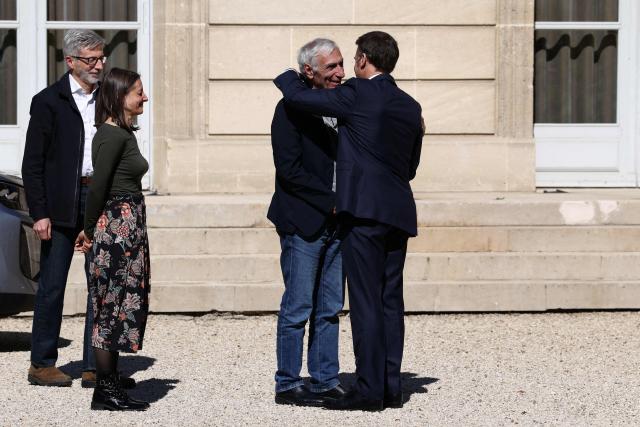 French President Emmanuel Macron (R) welcomes French national Jacques Paris freed by Iran after three and a half years in detention, at the Elysee Palace in Paris, on April 8, 2026. Two French nationals arrived in Paris on April 8, 2026 after spending more than three years in an Iranian prison on espionage charges, with President Emmanuel Macron hailing "the end of a terrible ordeal." (Photo by Tom Nicholson / POOL / AFP)