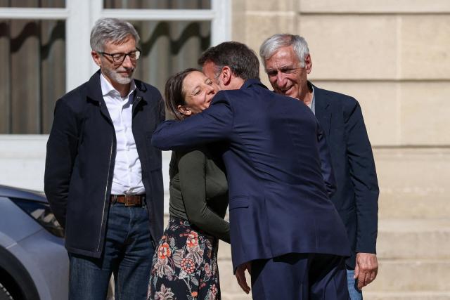 French President Emmanuel Macron (C-R), flanked by French ambassador to Iran Pierre Cochard (L), welcomes French national Cecile Kohler (C-L) and French National Jacques Paris (R) freed by Iran after three and a half years in detention, at the Elysee Palace in Paris, on April 8, 2026. Two French nationals arrived in Paris on April 8, 2026 after spending more than three years in an Iranian prison on espionage charges, with President Emmanuel Macron hailing "the end of a terrible ordeal." (Photo by Tom Nicholson / POOL / AFP)