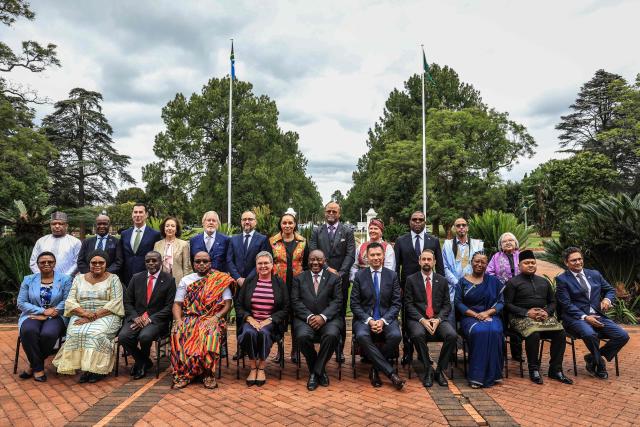 South African President Cyril Ramaphosa (seated C) poses for a photograph with various ambassadors after they presented their letters of credence during a ceremony at Sefako Makgatho Presidential Guest House in Pretoria on April 8, 2026. (Photo by Phill Magakoe / AFP)
