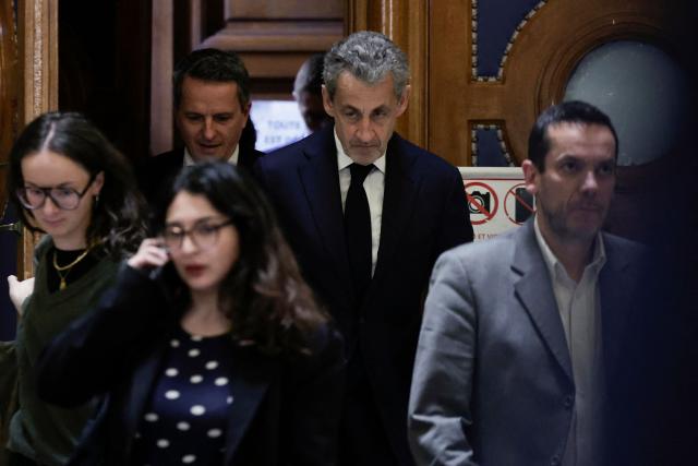 France's former President Nicolas Sarkozy leaves the court during his appeal trial over charges he sought Libyan financing for his 2007 election, at the Palais de Justice courthouse in Paris on April 8, 2026. The Paris Criminal Court in September 2025 convicted Sarkozy of criminal conspiracy and handed him a 5-year prison sentence over what it said was a scheme to acquire funding from Muammar Gaddafi's Libya for his 2007 presidential run that saw him elected. The right-wing politician -- who has denied any wrongdoing -- entered a Paris jail in October 2025, serving 20 days before he was released under judicial supervision. (Photo by STEPHANE DE SAKUTIN / AFP)