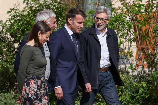 French President Emmanuel Macron (C-R), flanked by French ambassador to Iran Pierre Cochard (R), welcomes French national Jacques Paris (C-L) and French National Cecile Kohler (L) freed by Iran after three and a half years in detention, at the Elysee Palace in Paris, on April 8, 2026. Two French nationals arrived in Paris on April 8, 2026 after spending more than three years in an Iranian prison on espionage charges, with President Emmanuel Macron hailing "the end of a terrible ordeal." (Photo by Tom Nicholson / POOL / AFP)