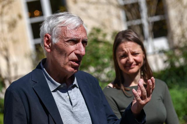 French nationals Jacques Paris (L) and Cecile Kohler (R) who were freed by Iran after three and a half years in detention speak to the press as they are hosted by French President at the Elysee Palace in Paris, on April 8, 2026. The pair had been under house arrest at the French embassy in Tehran ever since being freed from more than three years in prison in November, with their fate even more uncertain after US-Israeli strikes on Iran started on February 28. (Photo by Tom Nicholson / POOL / AFP)