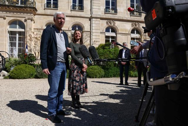 French nationals Jacques Paris (L) and Cecile Kohler (R) who were freed by Iran after three and a half years in detention speak to the press as they are hosted by French President at the Elysee Palace in Paris, on April 8, 2026. The pair had been under house arrest at the French embassy in Tehran ever since being freed from more than three years in prison in November, with their fate even more uncertain after US-Israeli strikes on Iran started on February 28. (Photo by Tom Nicholson / POOL / AFP)