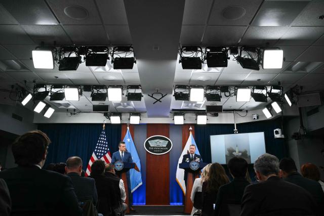 (L/R) US Secretary of Defense Pete Hegseth and Chairman of the Joint Chiefs of Staff Dan Caine speak during a press briefing at the Pentagon in Washington, DC, on April 8, 2026. The United States and Iran agreed to a two-week ceasefire on April 7 barely an hour before President Donald Trump's deadline to obliterate the country, triggering global relief alongside apprehension. Tehran has agreed to temporarily reopen the Strait of Hormuz, through which much of the world's oil, gas and fertiliser passes, easing concerns for the battered global economy. (Photo by Mandel NGAN / AFP)