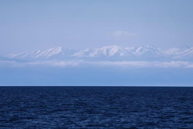 This photograph shows the Alps as seen from the Mediterranean sea, off the coast of Marseille, on April 7, 2026. (Photo by Thibaud MORITZ / AFP)
