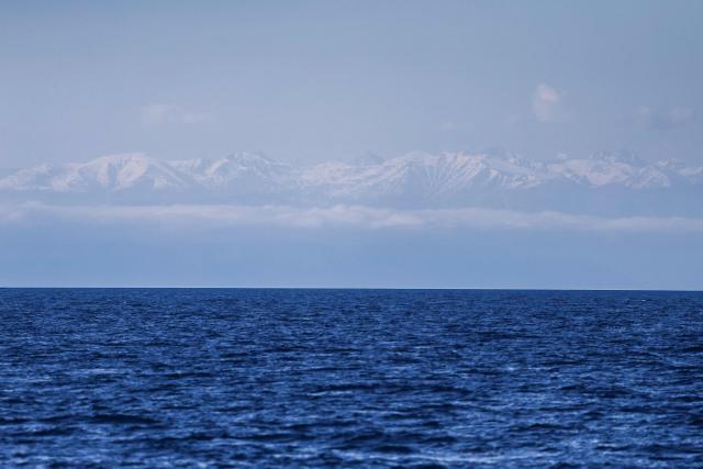 This photograph shows the Alps as seen from the Mediterranean sea, off the coast of Marseille, on April 7, 2026. (Photo by Thibaud MORITZ / AFP)