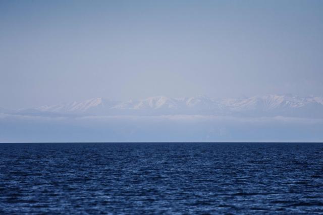 This photograph shows the Alps as seen from the Mediterranean sea, off the coast of Marseille, on April 7, 2026. (Photo by Thibaud MORITZ / AFP)