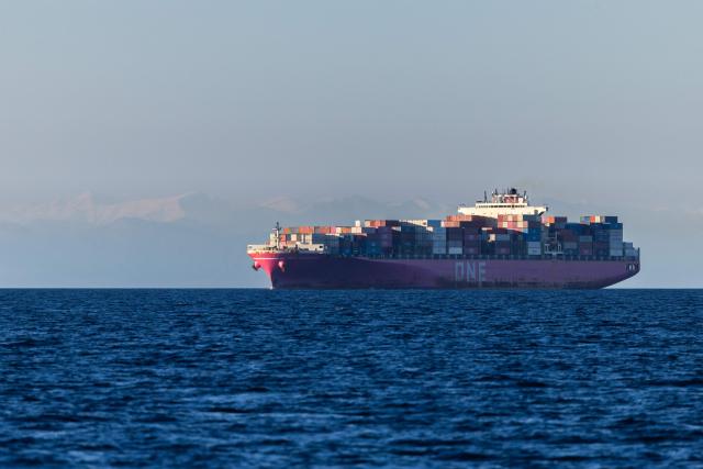 An Ocean Network Express (ONE) container ship sails off the southeastern Mediterranean coast of France with the Corsican mountains in the background in Marseille on April 7, 2026. (Photo by Thibaud MORITZ / AFP)