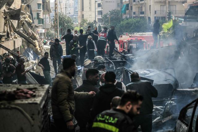 First responders and residents stand amid rubble at the site of an Israeli airstrike in Beirut's Corniche al-Mazraa neighbourhood on April 8, 2026. Israel launched a series of strikes in Beirut on April 8, causing panic among residents in the most violent attack on the capital since the start of the war with Hezbollah. The Israeli military said it carried out its "largest coordinated strike across Lebanon". Israel has insisted the two-week truce in its war with Iran does not apply to Lebanon. (Photo by ibrahim AMRO / AFP)
