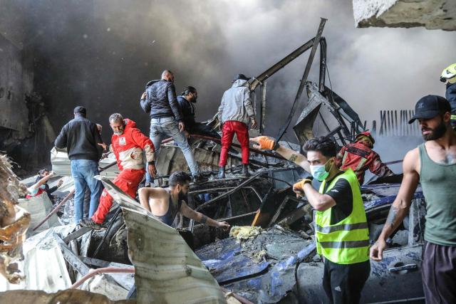 First responders and residents stand amid rubble at the site of an Israeli airstrike in Beirut's Corniche al-Mazraa neighbourhood on April 8, 2026. Israel launched a series of strikes in Beirut on April 8, causing panic among residents in the most violent attack on the capital since the start of the war with Hezbollah. The Israeli military said it carried out its "largest coordinated strike across Lebanon". Israel has insisted the two-week truce in its war with Iran does not apply to Lebanon. (Photo by Ibrahim AMRO / AFP)